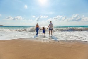 Photo of a family on the beach from Natalya Zaritskaya on Unsplash