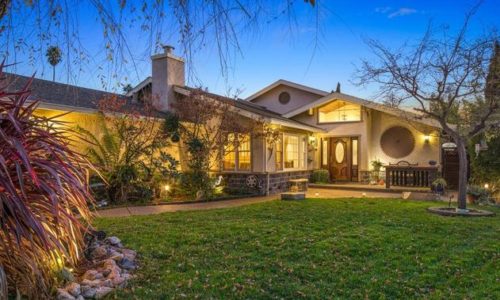 a beautiful sunset shot of the sold Donna Street house and front lawn